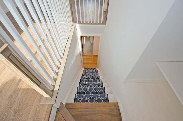 stairway featuring wood-type flooring