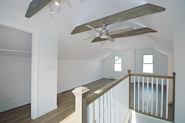 corridor featuring dark hardwood / wood-style flooring, vaulted ceiling with beams, and track lighting