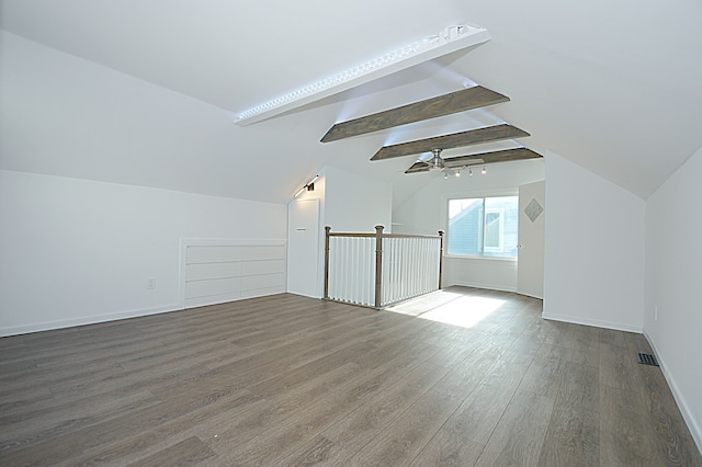 bonus room featuring hardwood / wood-style floors, vaulted ceiling with beams, and ceiling fan