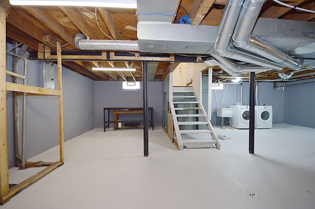 basement featuring washing machine and dryer and sink