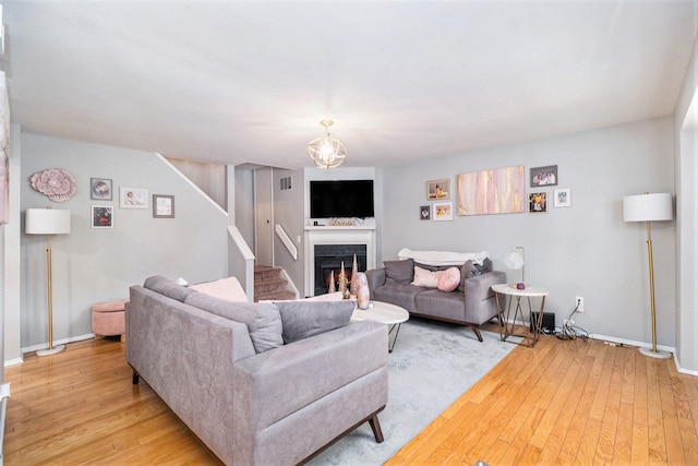 living room with an inviting chandelier and light hardwood / wood-style floors