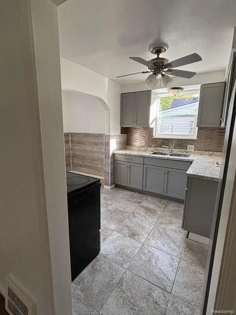 kitchen with gray cabinets, sink, and black range with electric cooktop