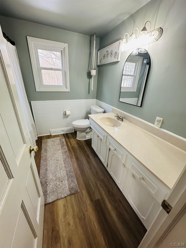 bathroom featuring hardwood / wood-style flooring, vanity, and toilet