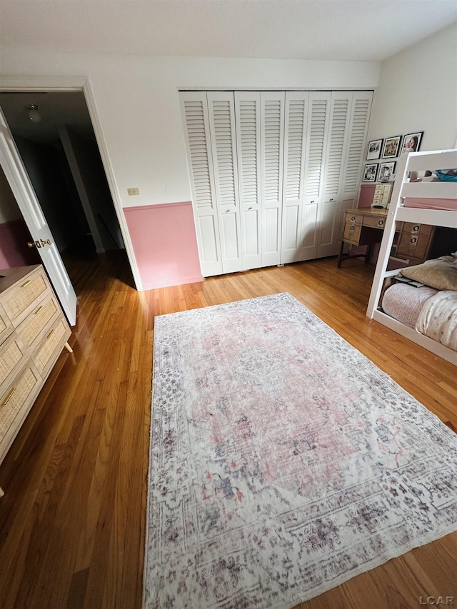 bedroom featuring hardwood / wood-style floors and a closet