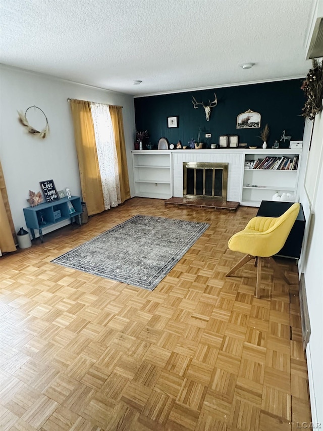 living room with light parquet flooring, a fireplace, and a textured ceiling