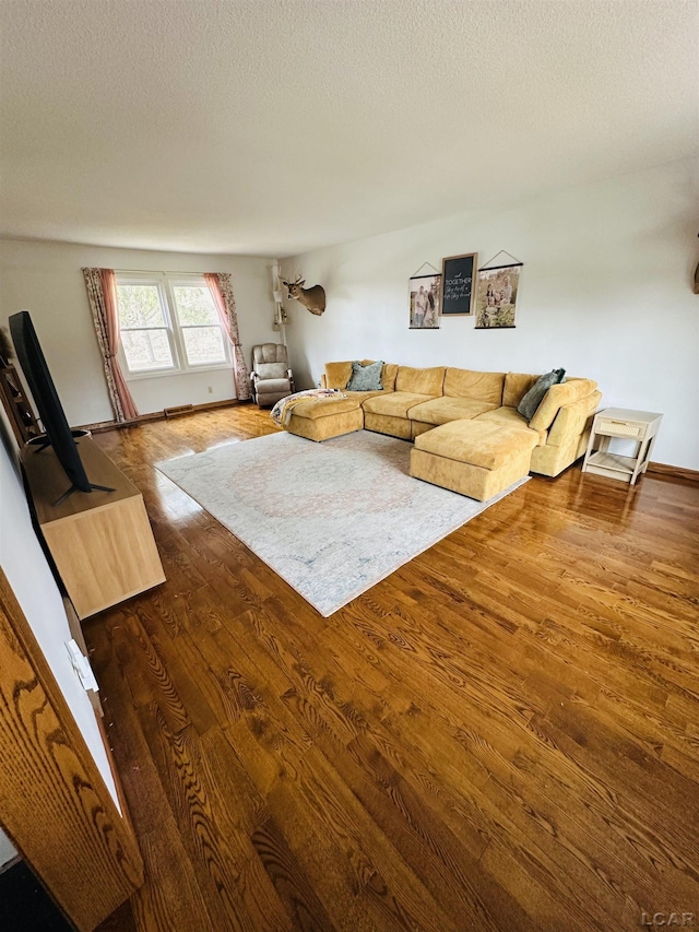 living room featuring hardwood / wood-style floors and a textured ceiling