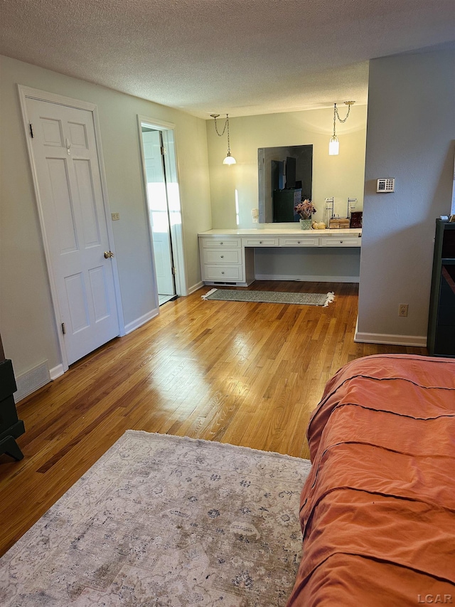 living room with hardwood / wood-style flooring and a textured ceiling