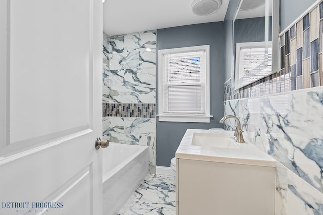 bathroom featuring tiled shower / bath and vanity