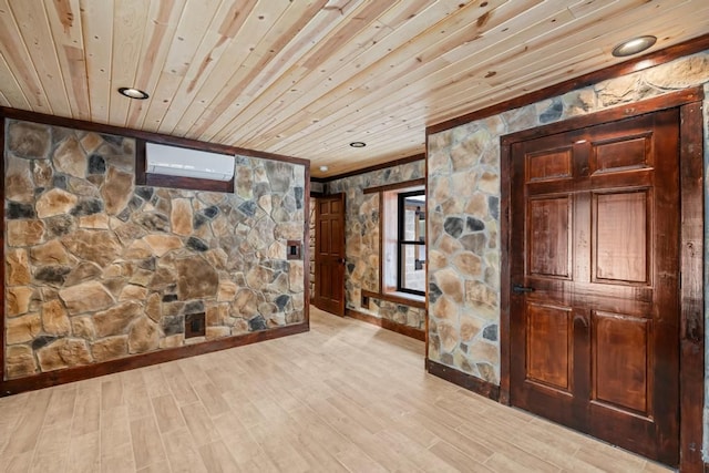 hall with ornamental molding, a wall mounted AC, light wood-type flooring, and wooden ceiling