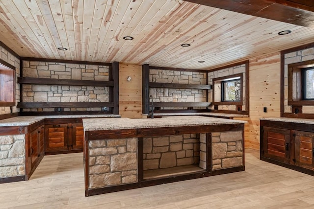 bar featuring light stone counters, wooden ceiling, and light hardwood / wood-style floors