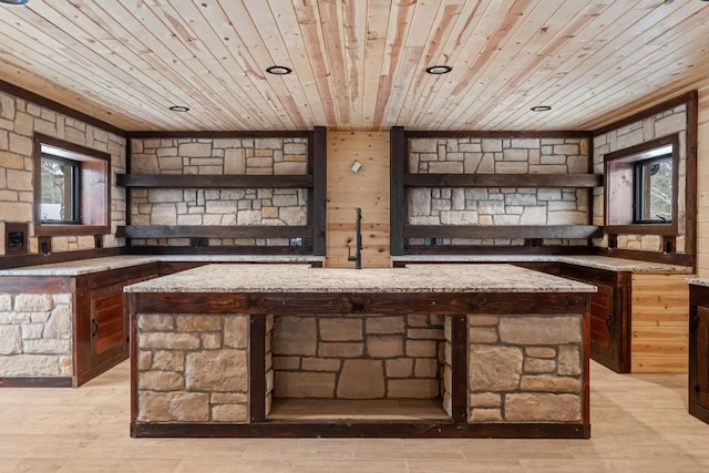 bar featuring sink, wood ceiling, light hardwood / wood-style flooring, and light stone countertops