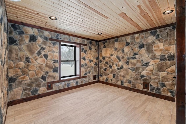 spare room featuring wood ceiling and light hardwood / wood-style floors