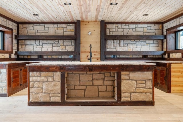 bar featuring sink, wooden ceiling, wood walls, and light wood-type flooring