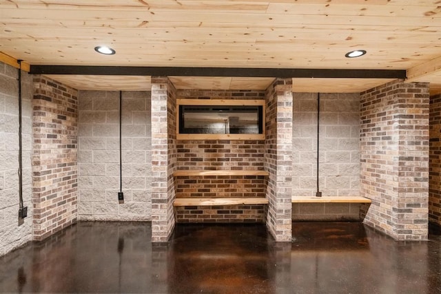 bathroom with concrete floors and wood ceiling