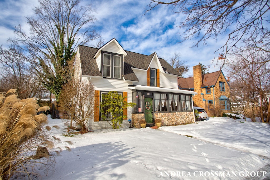 view of front of home featuring a sunroom