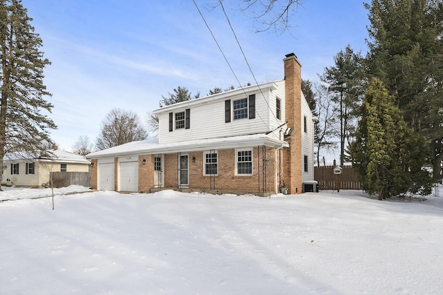 view of front facade featuring central AC unit and a garage