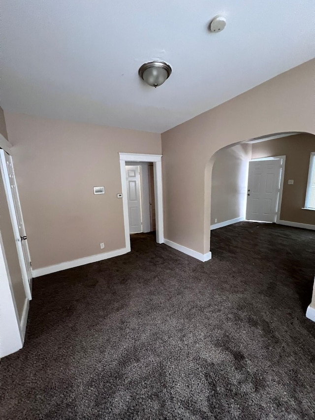 empty room featuring dark colored carpet