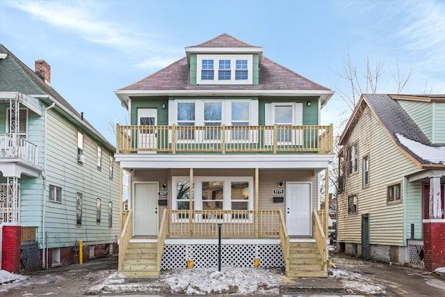 view of front of property featuring a balcony and a porch