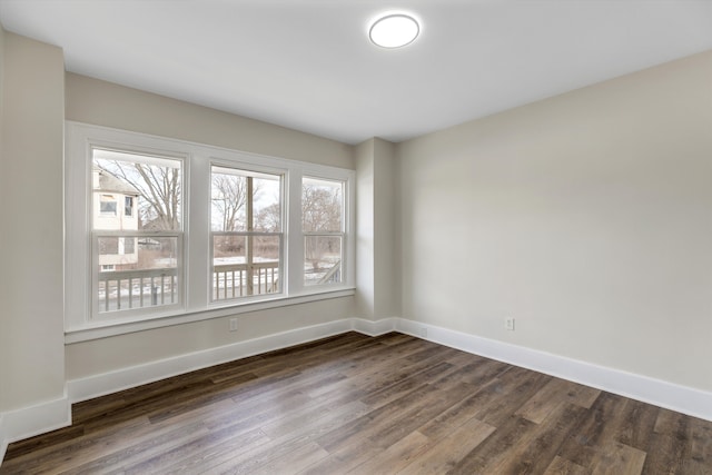 empty room with dark hardwood / wood-style floors