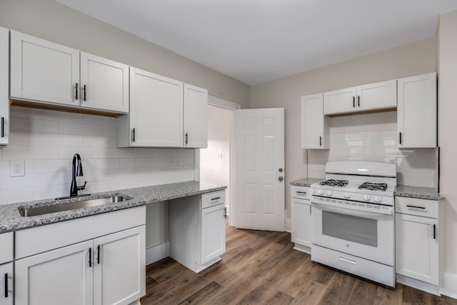 kitchen featuring sink, dark wood-type flooring, light stone counters, white cabinets, and white gas range