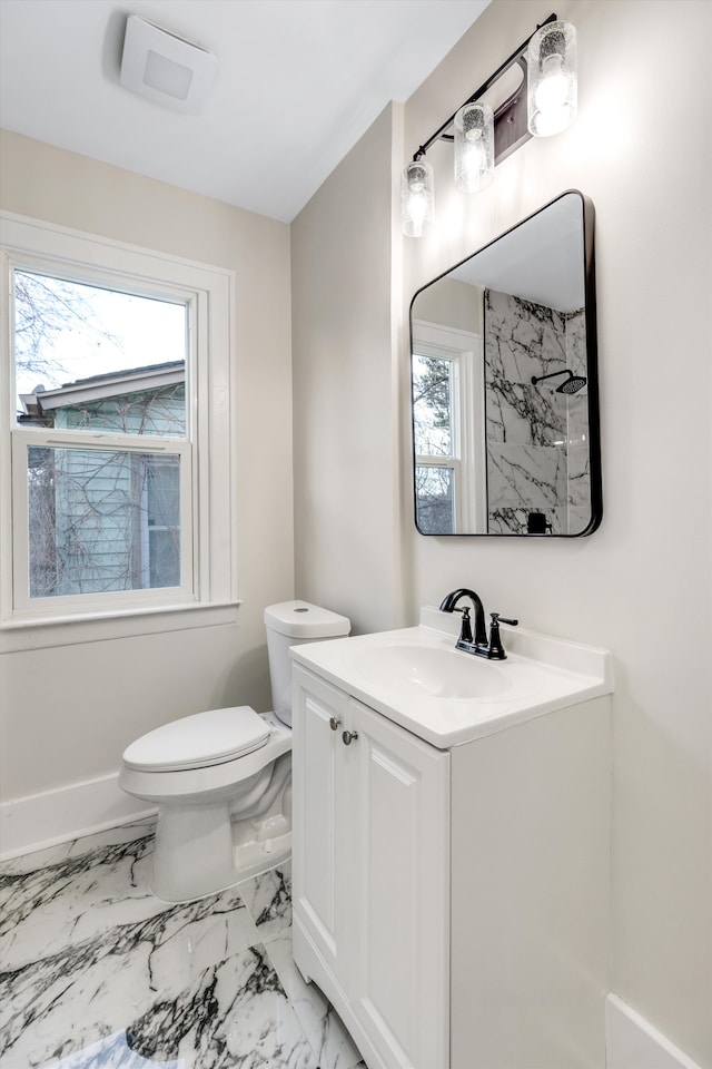 bathroom featuring a healthy amount of sunlight, toilet, vanity, and a shower