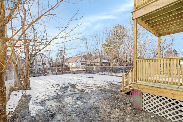 yard covered in snow featuring a deck