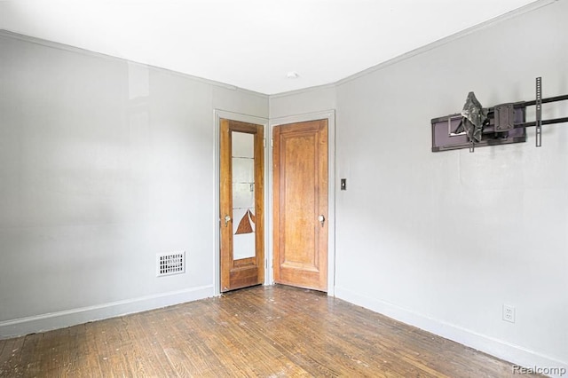 spare room featuring wood-type flooring