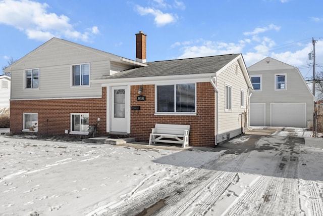 snow covered property featuring a garage