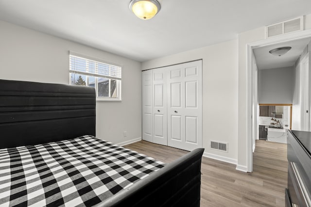 bedroom with a closet and light wood-type flooring