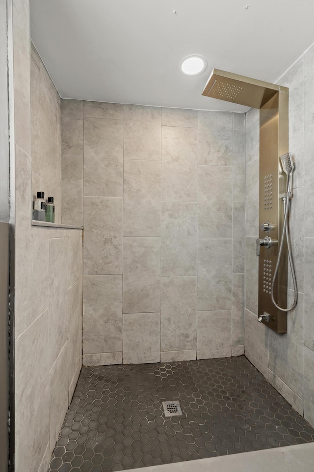 bathroom with tiled shower