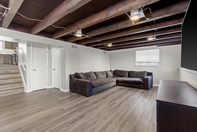 living room featuring hardwood / wood-style flooring and beamed ceiling