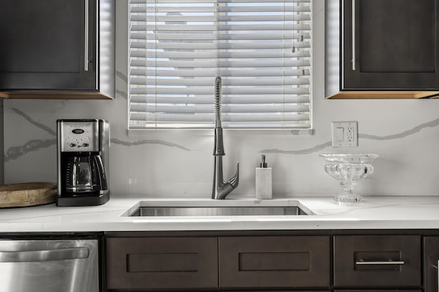 interior space featuring dishwasher, plenty of natural light, sink, and backsplash