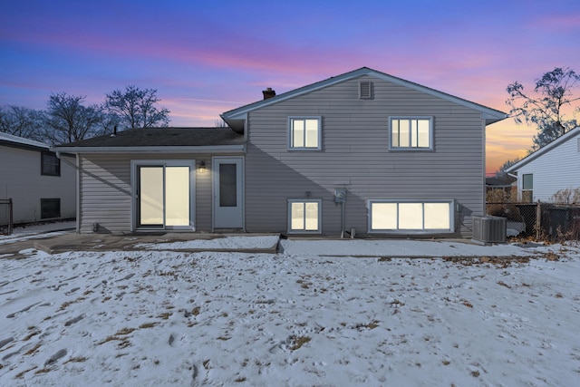 snow covered property featuring central air condition unit