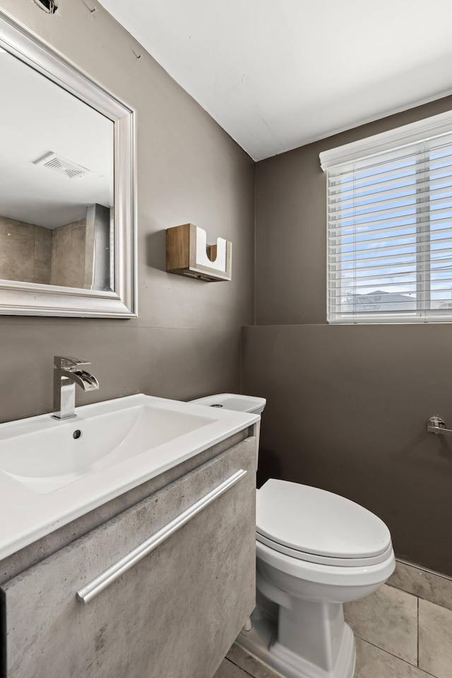 bathroom with vanity, toilet, and tile patterned flooring