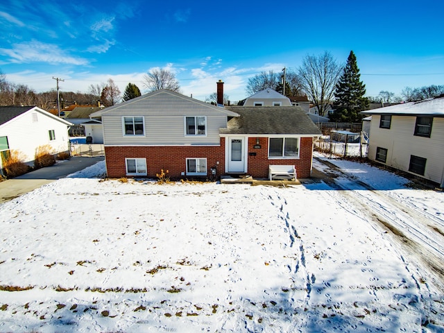 view of snow covered rear of property