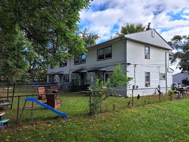 back of property featuring a yard