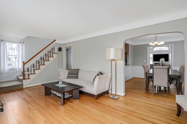 living room with a notable chandelier and light wood-type flooring