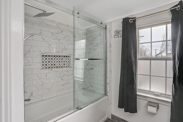 bathroom with shower / bath combination with glass door