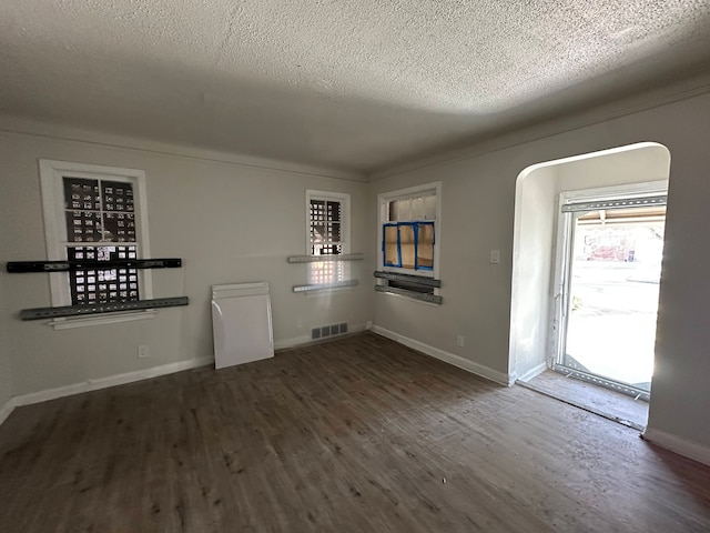 interior space featuring dark hardwood / wood-style flooring and a textured ceiling