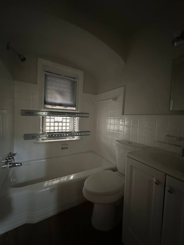 full bathroom featuring toilet, tub / shower combination, tile walls, vanity, and decorative backsplash