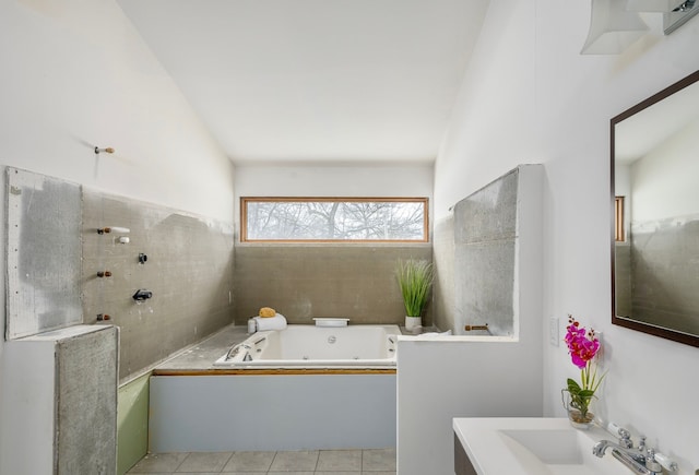 bathroom featuring sink, a bath, and tile patterned floors