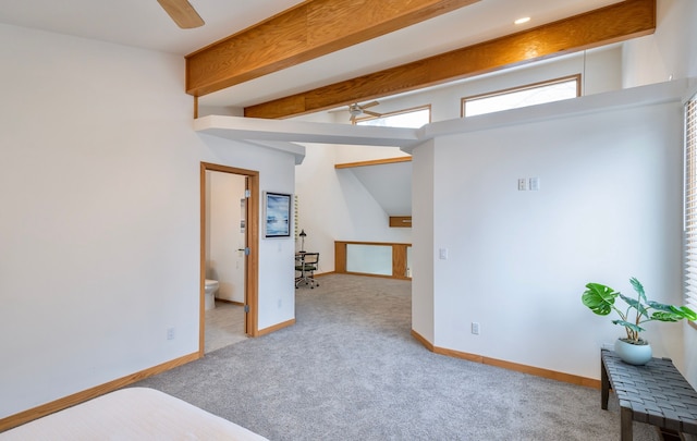 interior space with vaulted ceiling with beams and ceiling fan