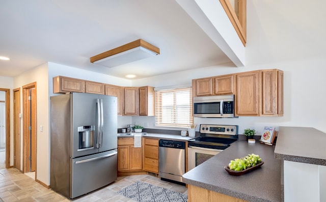 kitchen featuring stainless steel appliances and kitchen peninsula