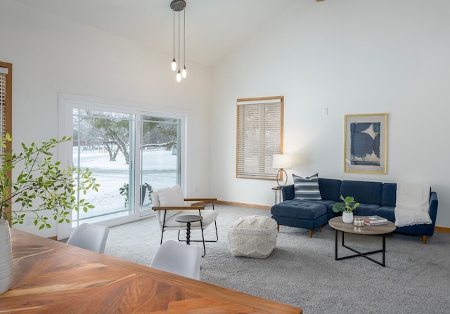 living room featuring carpet flooring and high vaulted ceiling