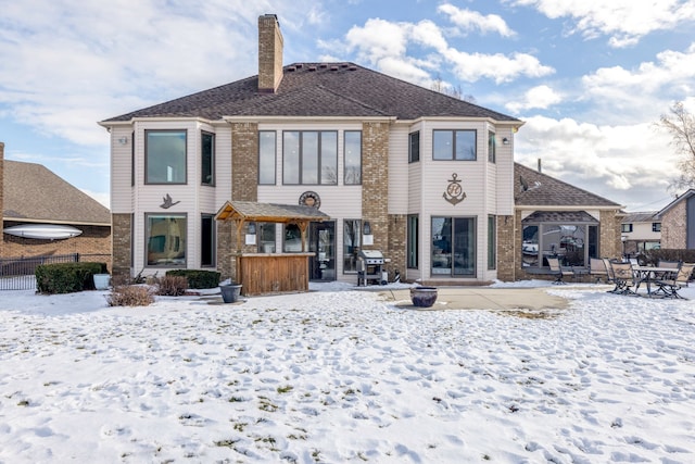 view of snow covered rear of property