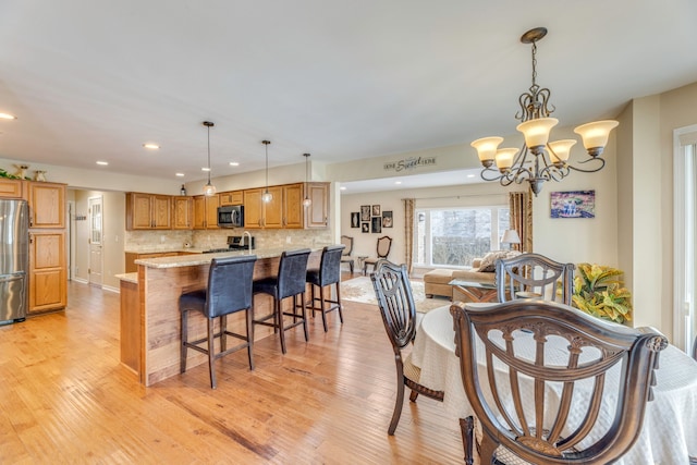 dining room featuring a chandelier and light hardwood / wood-style flooring