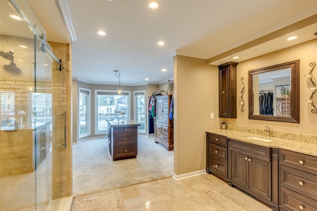 bathroom featuring vanity, a shower with door, and ornamental molding