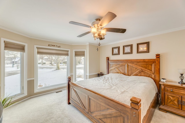 bedroom featuring light carpet, crown molding, and ceiling fan