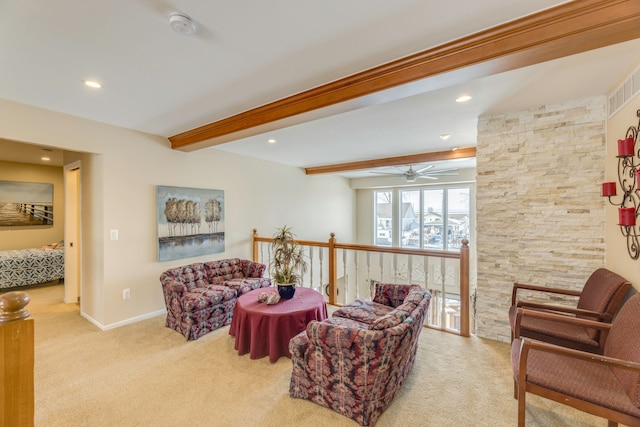 carpeted living room with beamed ceiling