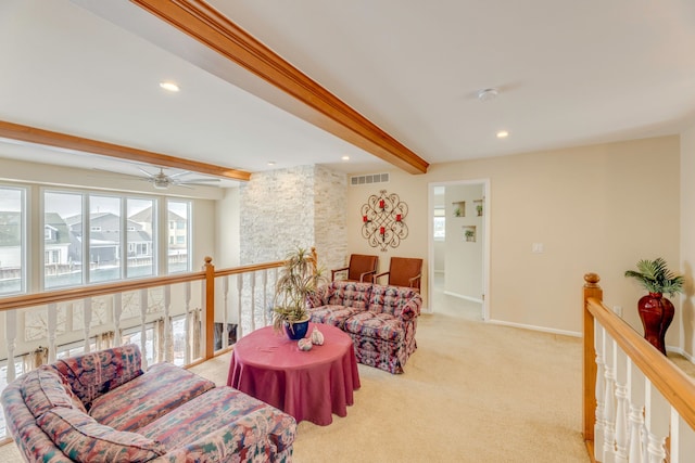 living room featuring light carpet and beamed ceiling